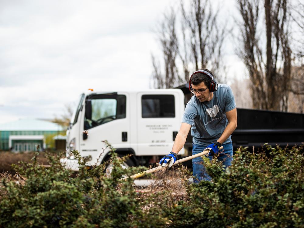 BYU Grounds student raking