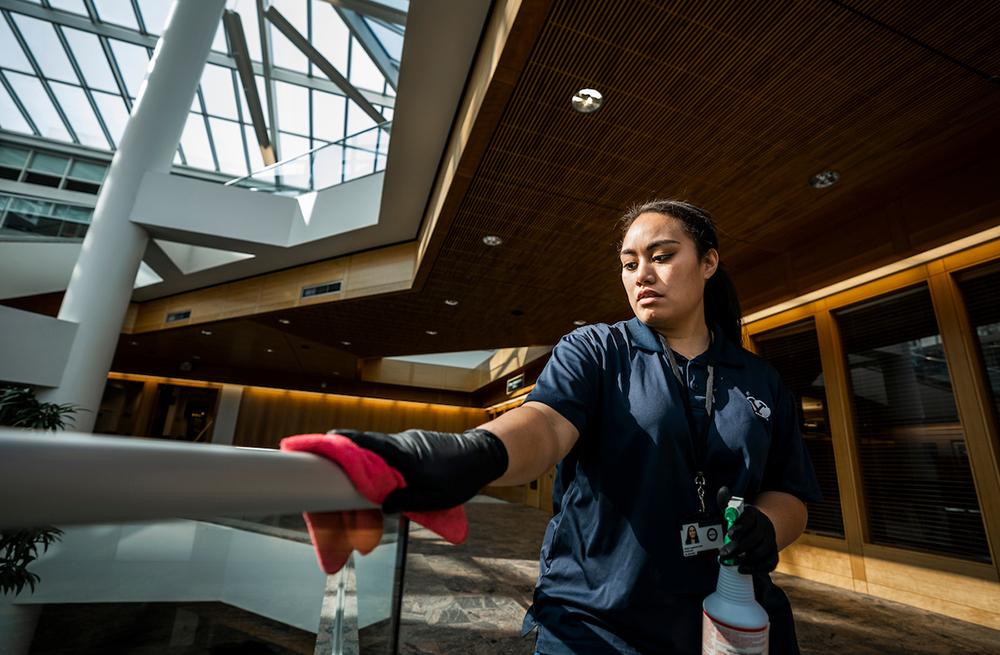 BYU student wiping down a railing